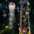 Jellyfish Lamp - Side view of Lavender Color jellyfish,  illuminated In garden.